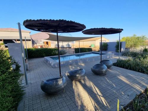 a group of metal pots sitting under an umbrella at Excelsior Country House in Porterville