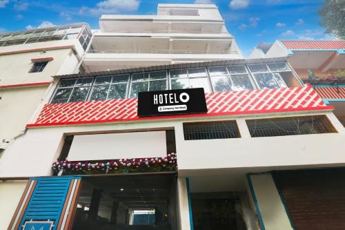 a hotel sign on the front of a building at Super Hotel O Kadam Ghat Near Ashok RajPath in Patna