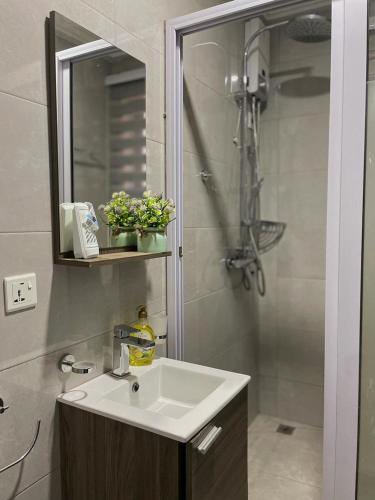 a bathroom with a sink and a shower at ENA Apartments in Apenkwa