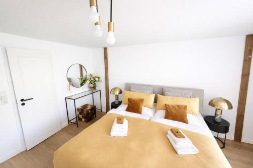 a bedroom with a large bed with two towels on it at Suite Dreams Bremen in Bremen