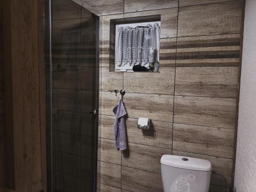 a bathroom with a toilet and a glass shower at Chalupa M&P 2 in Bešeňová