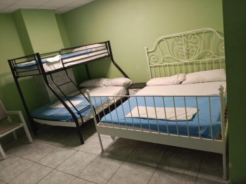 a couple of bunk beds in a room at Tenerife Hostel in Los Cristianos