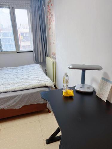 a room with a desk and a bed and a table with a chair at Private room on the 6th floor in Beijing