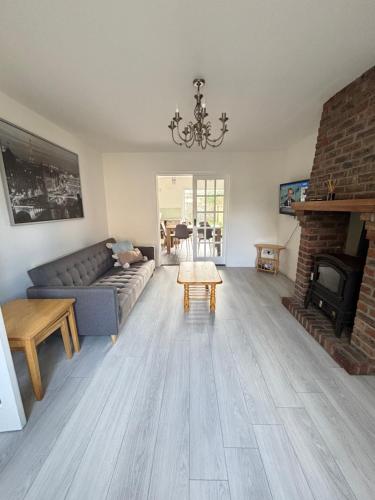 a living room with a couch and a fireplace at Villa nxt Rock, Cashel palace in Cashel