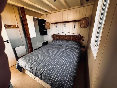 a bedroom with a bed in a small room at Martinette in Saint-Pair-sur-Mer