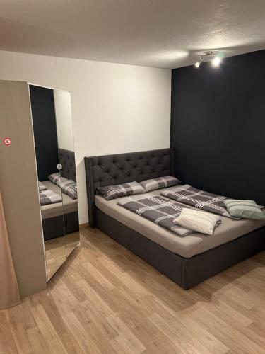 a bedroom with a large bed and a mirror at Ferienwohnung Kestel in Bad Bellingen
