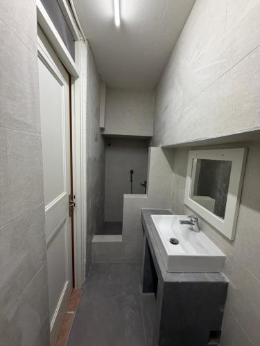 a bathroom with a sink and a mirror at Phoenix Cosy Home L in Livadi