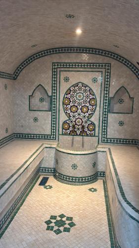 a large room with a fountain in a building at Dar Hachemia in Ras El Ma