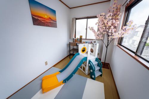 a kids room with a slide and a tree at Holiday Home 3 Floors 115 m Near Haneda Airport 6 Bedrooms Sleeps 9 in Tokyo