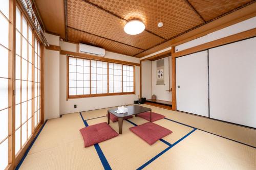 a room with a table and two red chairs at Holiday Home 3 Floors 115 m Near Haneda Airport 6 Bedrooms Sleeps 9 in Tokyo