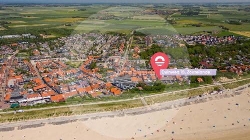 an aerial view of a city with a beach at Welcome in - Appartement aan de duinen met balkon I Duinweg 18, Zoutelande 'Duinroos' in Zoutelande
