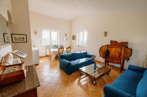 a living room with a blue couch and a table at Gli olivi in Formello