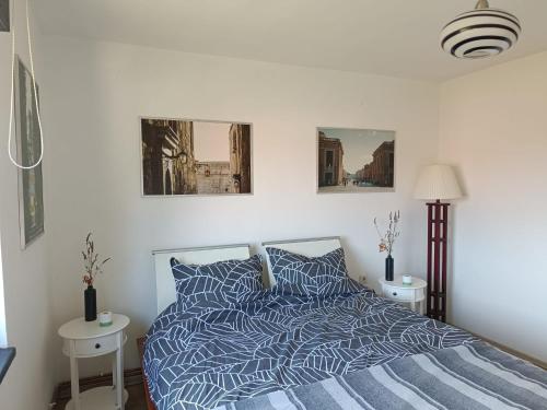 a bedroom with a bed with a blue and white comforter at Apartman Novak in Samobor
