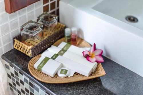 a plate with towels and a flower on a counter at Delux Villa in Battambang