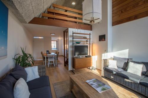 a living room with a couch and a table at Welcome in - Appartement met balkon in Veere I Kievitenlaan 22 in Veere
