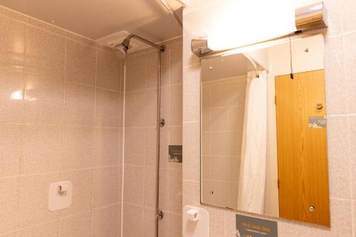 a bathroom with a shower and a mirror at De Trafford Arms by Chef & Brewer Collection in Alderley Edge