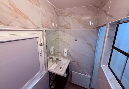 a bathroom with a sink and a shower at Class'eco Charleroi in Charleroi