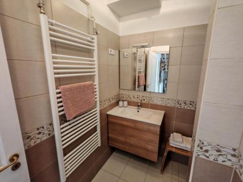 a bathroom with a sink and a mirror at Beta Apartman in Bük