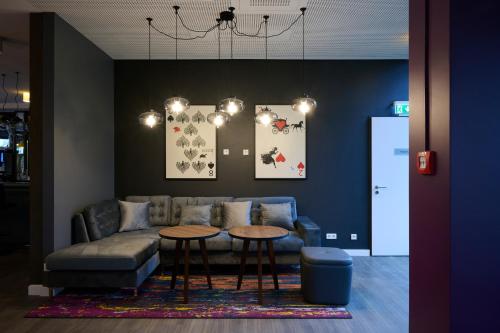 a living room with a couch and a table at Premier Inn Freiburg City Nord in Freiburg im Breisgau