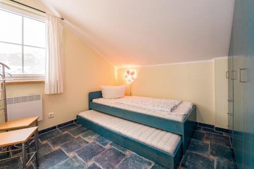 a small bedroom with a bed and a desk at Ferienhaus Seestern - Bade- & Saunawelt täglich inklusive in Baabe