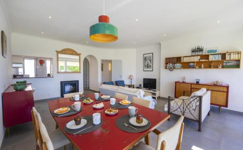 a dining room and living room with a red table at C12 - Sunshine Apartment in Luz in Luz