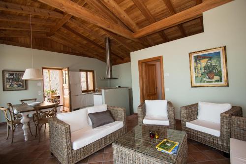a living room with a couch and chairs and a table at VillaLimone in Limone sul Garda