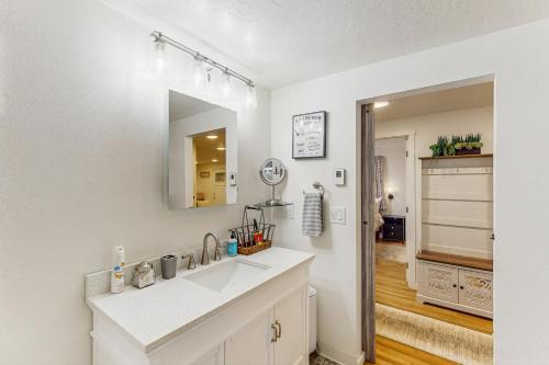 a white bathroom with a sink and a mirror at Mountain-View Patio, 1 Mi From UO Campus in Eugene