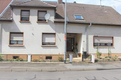 a white house with a porch and a door at Fewo in Weierbach bei Idar-Oberstein in Idar-Oberstein
