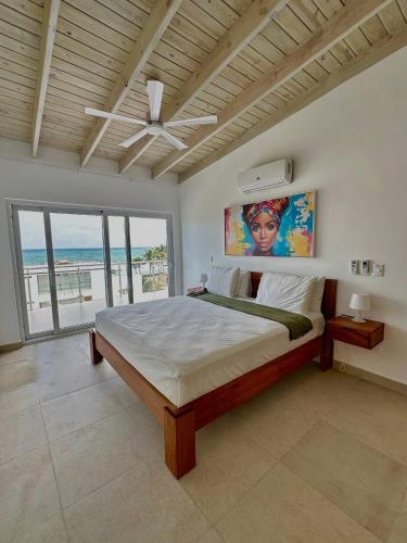 a bedroom with a bed with a ceiling fan at Mananero III in Sosúa