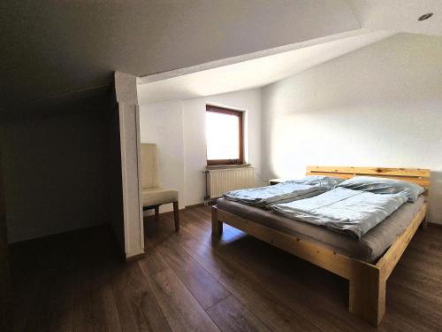 a bedroom with a bed in a room with a window at Sonnenblumen in Hörbranz