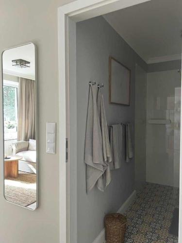 a bathroom with a mirror on the wall at Apartament w Sosnowym SPA in Serock