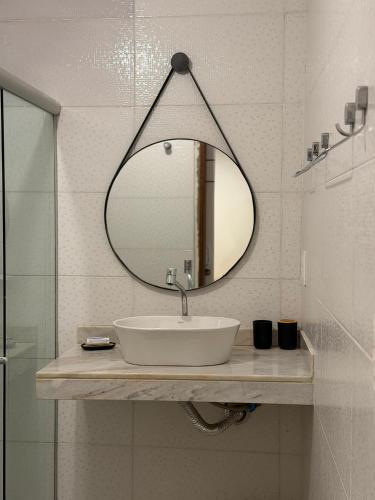 a bathroom with a sink and a mirror at Casinha Verde, Itacaré in Itacaré