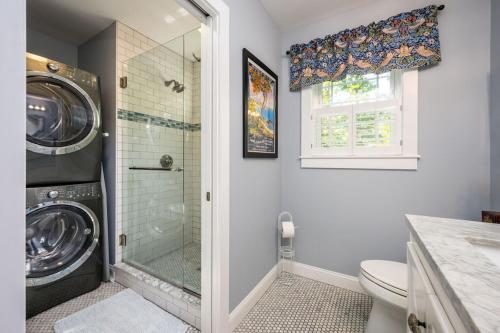 a bathroom with a washing machine and a shower at Colonels Quarters in Kennebunk
