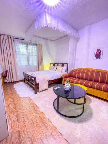 a living room with a bed and a coffee table at R 19 Kogelo Villas in Kisumu