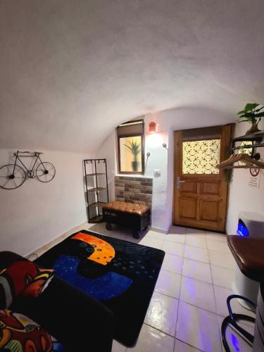 a living room with a couch and a table at Tiny studio, rustic style, historic center in Sanremo