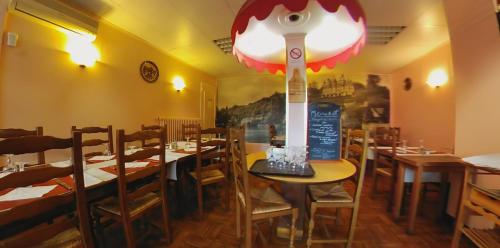 un restaurant avec des tables et des chaises dans une salle dans l'établissement Hotel Au Bon Coin, à Cloyes-sur-le-Loir