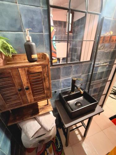 a bathroom with a sink and a mirror at Tiny studio, rustic style, historic center in Sanremo