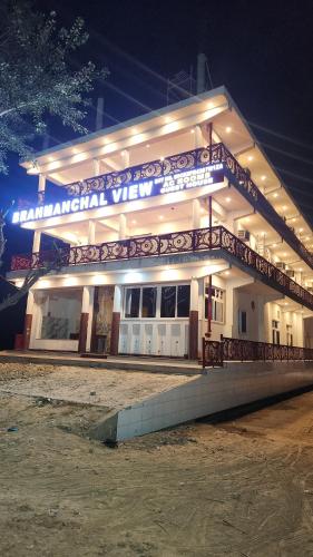 a building with a sign on it at night at BRAHMANCHAL guest house in Barsāna