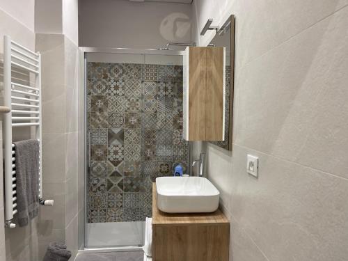 a bathroom with a white sink and a shower at Casa di WR in Imperia