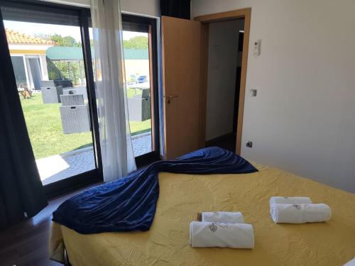 a bedroom with a bed with two towels on it at Quinta Salinas - Puro Prazer in Aveiro