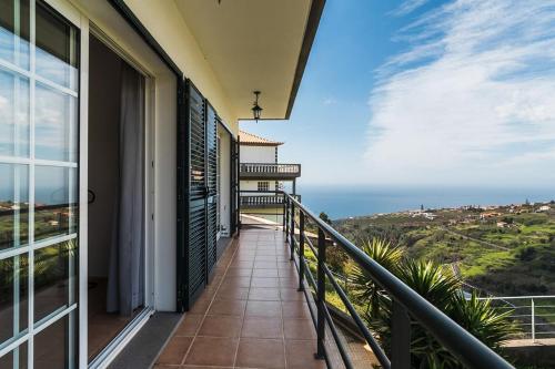 a balcony with a view of the ocean at GuestReady - Casa das Estrelas in Estreito da Calheta