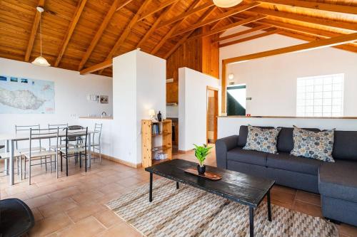 a living room with a couch and a table at GuestReady - Casa das Estrelas in Estreito da Calheta