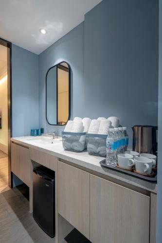 a bathroom with a counter with a sink and a mirror at Explore Hotel in Taichung