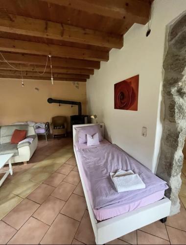 a bedroom with a bed in the corner of a room at Hotel Garni Silberdistel in Nenningen