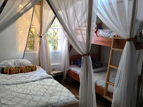 a bedroom with two bunk beds and a window at Mizpah House in Kikuyu