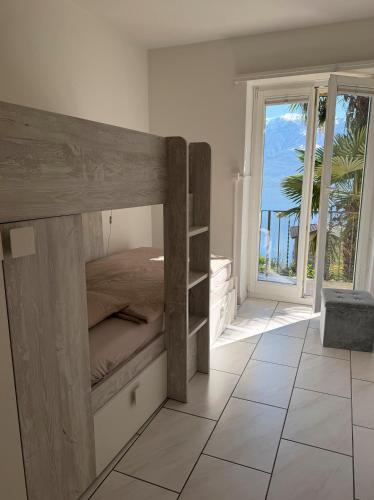 a bedroom with a bunk bed with a view of the ocean at Molino Vecchio in Ronco sopra Ascona