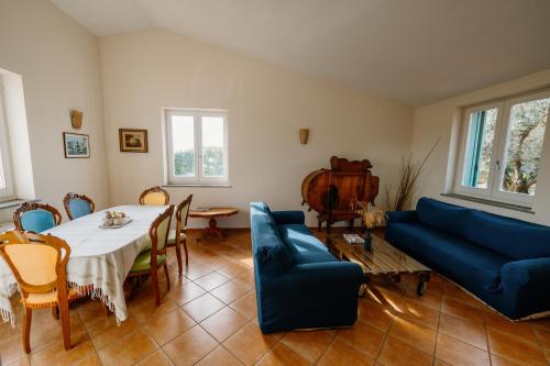 a living room with a table and a blue couch at Gli olivi in Formello