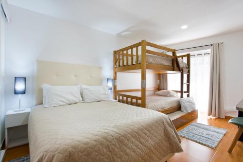 a bedroom with a bed and a bunk bed at Braganca Oporto in Porto