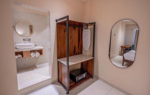 a bathroom with a sink and a mirror at Indie Stays Studio Kharadi in Pune