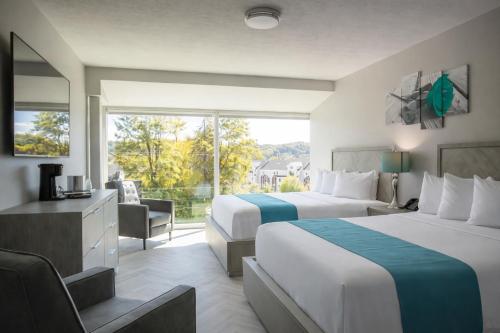 a hotel room with two beds and a window at Athens Central Hotel in Athens